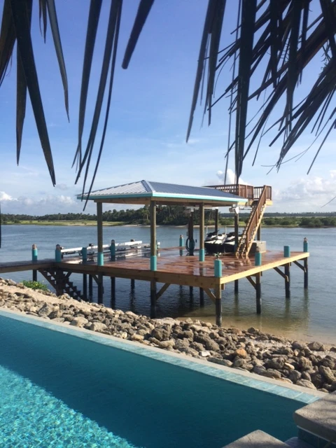 Pool beside on the sea with retaining walls and a wooden deck and dock
