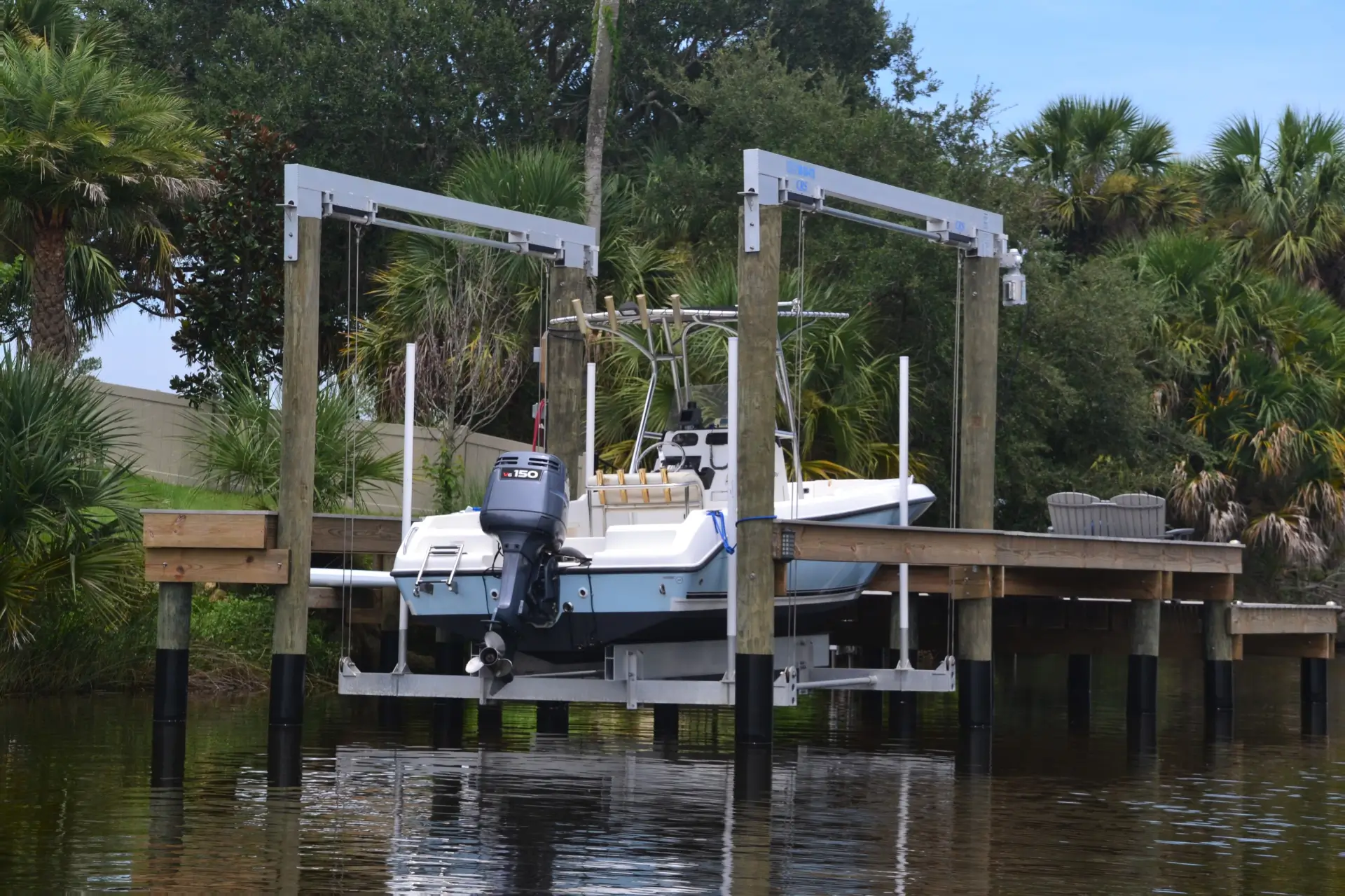 Pvc deck and dock with boat on it featuring forest view on the background