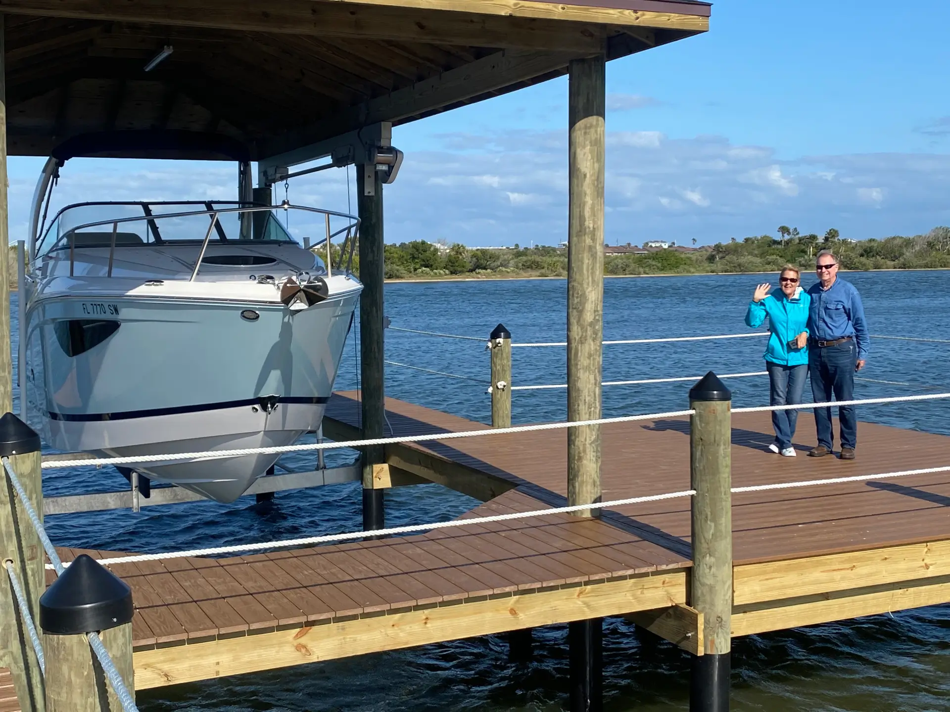 Pvc decking dock with boat on it and with the owner