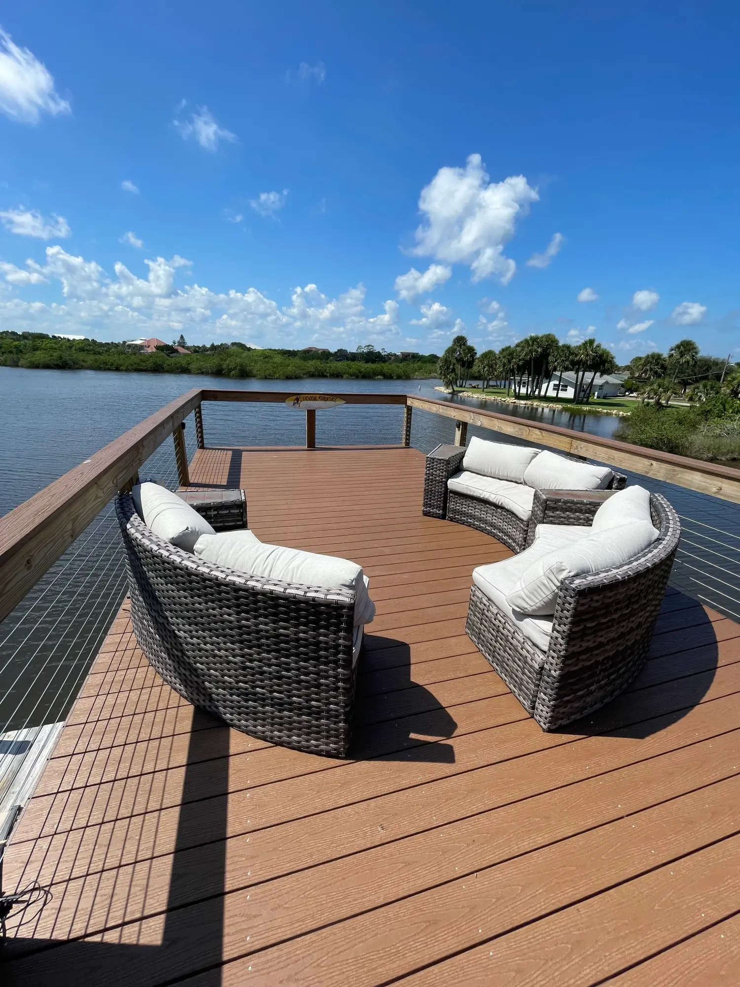 Residential deck with wire railing and outside furniture on the florida