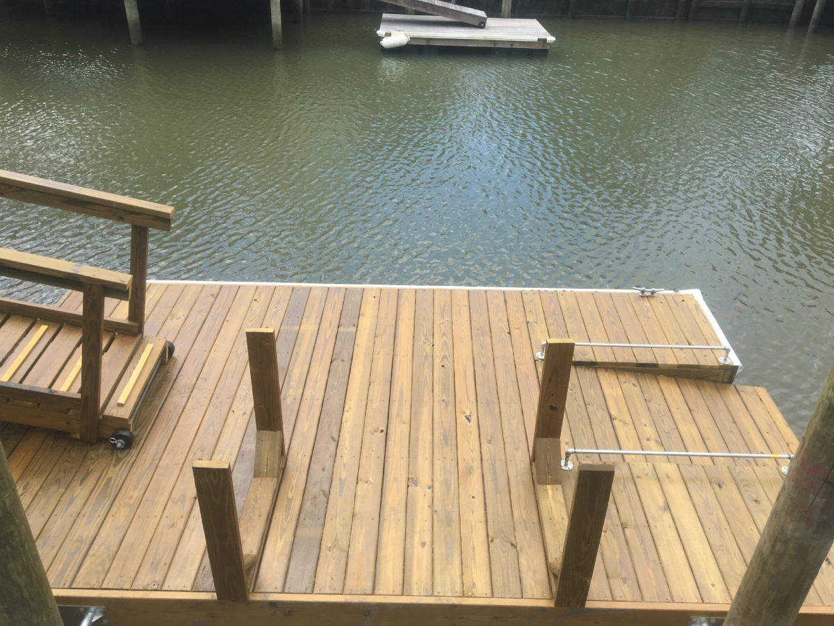 Residential dock installation with wooden stairs