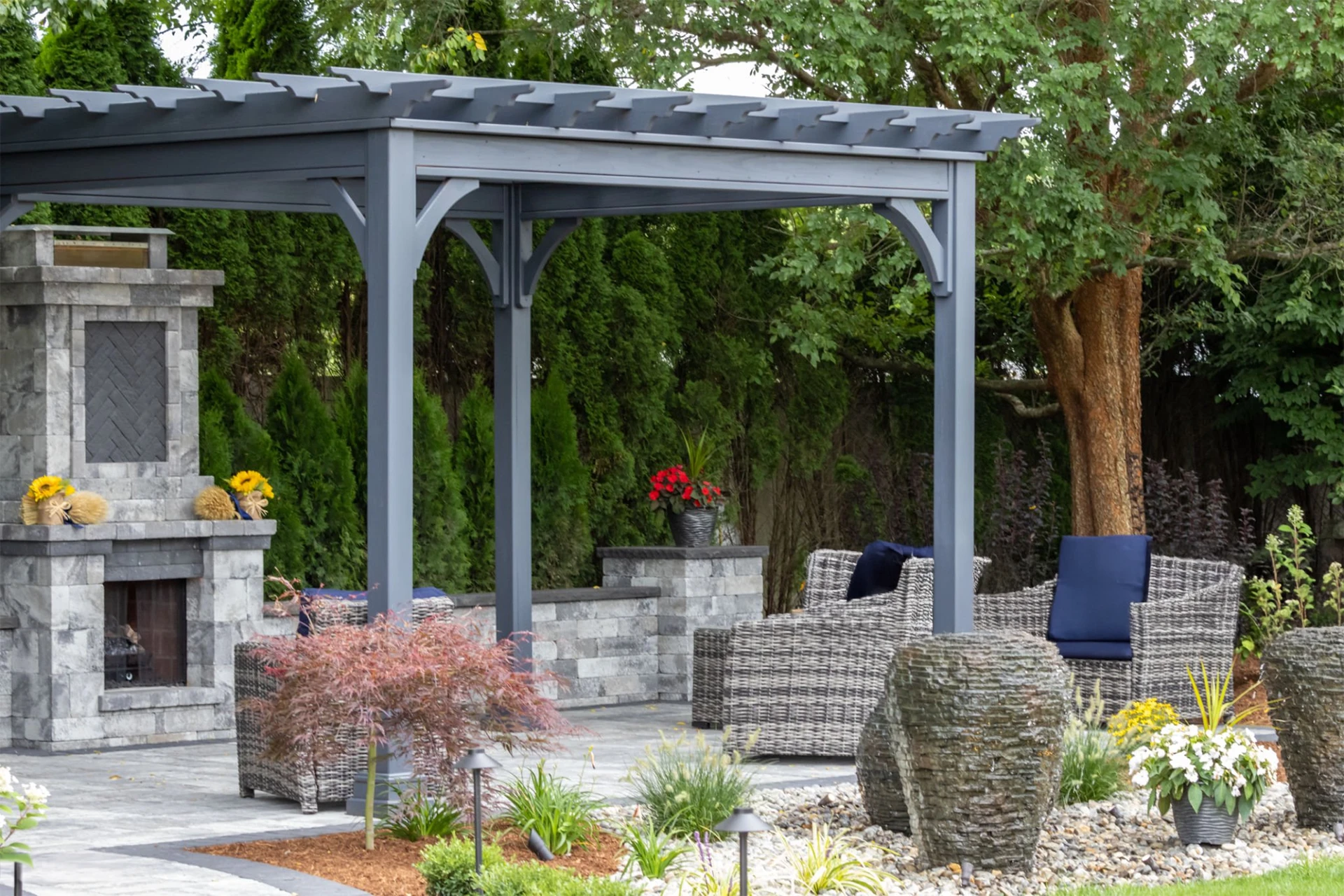 Sk landscape architecture featuring pergola and stone fireplace